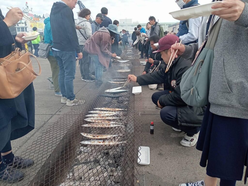 秋刀魚を焼く人の写真